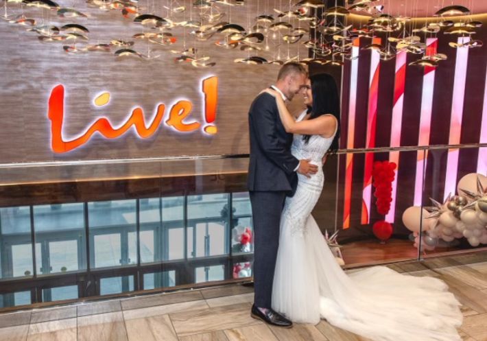 Inside Live!, a bride and groom hold each other close, smiling. Let us make your day perfect, so you can focus on each other!